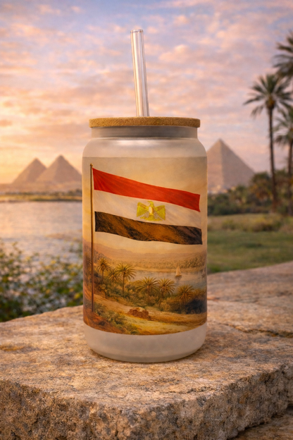 Tumbler with scenic design against a backdrop of pyramids and palm trees.